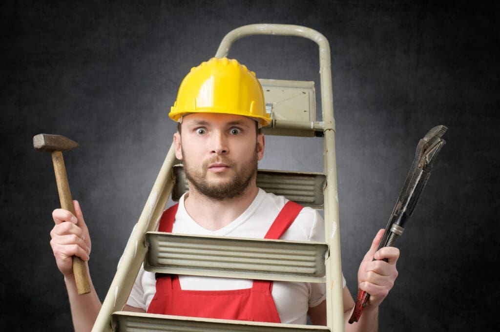 worker with ladder around his neck holding tools