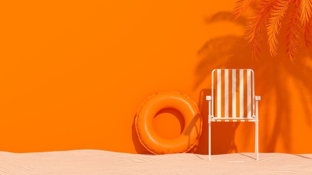 summer beach background with palm tree, chair, and inflatable ring on sand 