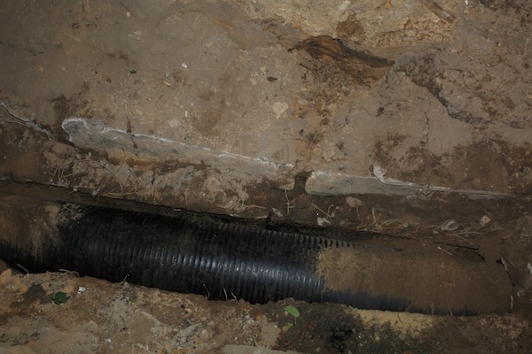 A pipe uncovered in the dirt when underground tunneling is worth it to a customer